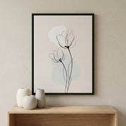 Minimalist tulip line art print in a black frame, styled in a modern living room above a wooden console table with neutral decor.
