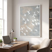 Framed minimalist white dove Christian wall art featuring peaceful flying doves, displayed above a wooden desk with a laptop and lamp in a modern home office.