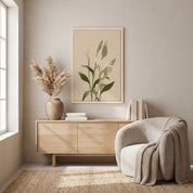 Minimalist white lily vertical framed canvas Christian wall art in soft sage green displayed above a light wood sideboard in an organic modern living room.