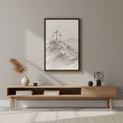 Three Crosses Christian line art in a dark wood frame, styled on a neutral wall above a modern wooden console table with pampas grass decor.