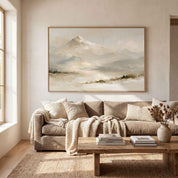 Framed vintage Psalm 121:2 Christian landscape canvas wall art featuring snow-capped mountains hanging on a beige wall above a warm beige sofa and rustic wooden coffee table in a modern organic living room.