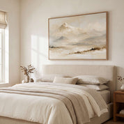 Framed vintage Psalm 121:2 Christian landscape canvas wall art featuring snow-capped mountains hanging on a beige wall above an upholstered bed in a warm neutral bedroom.