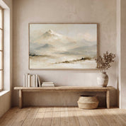Framed vintage Psalm 121:2 Christian landscape canvas wall art featuring snow-capped mountains hanging on a textured beige wall above a rustic wooden entryway bench with books, a ceramic vase with dried foliage, and a woven basket.
