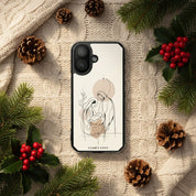 Nativity Scene Christian MagSafe iPhone case surrounded by pine branches, red berries, pinecones, and cozy knit fabric featuring minimalist Holy Family artwork with warm Christmas aesthetic