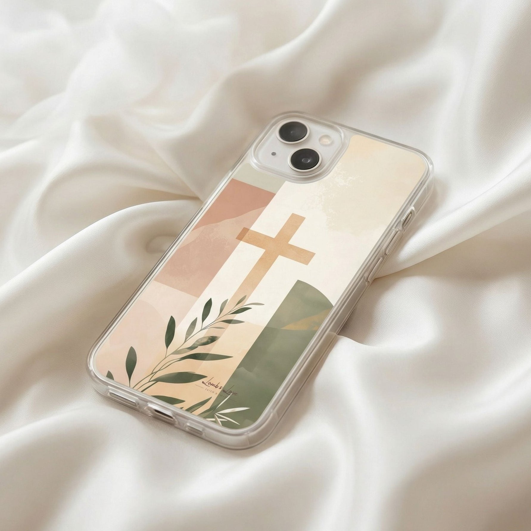 Phone case with cross and leaf design on a white fabric background