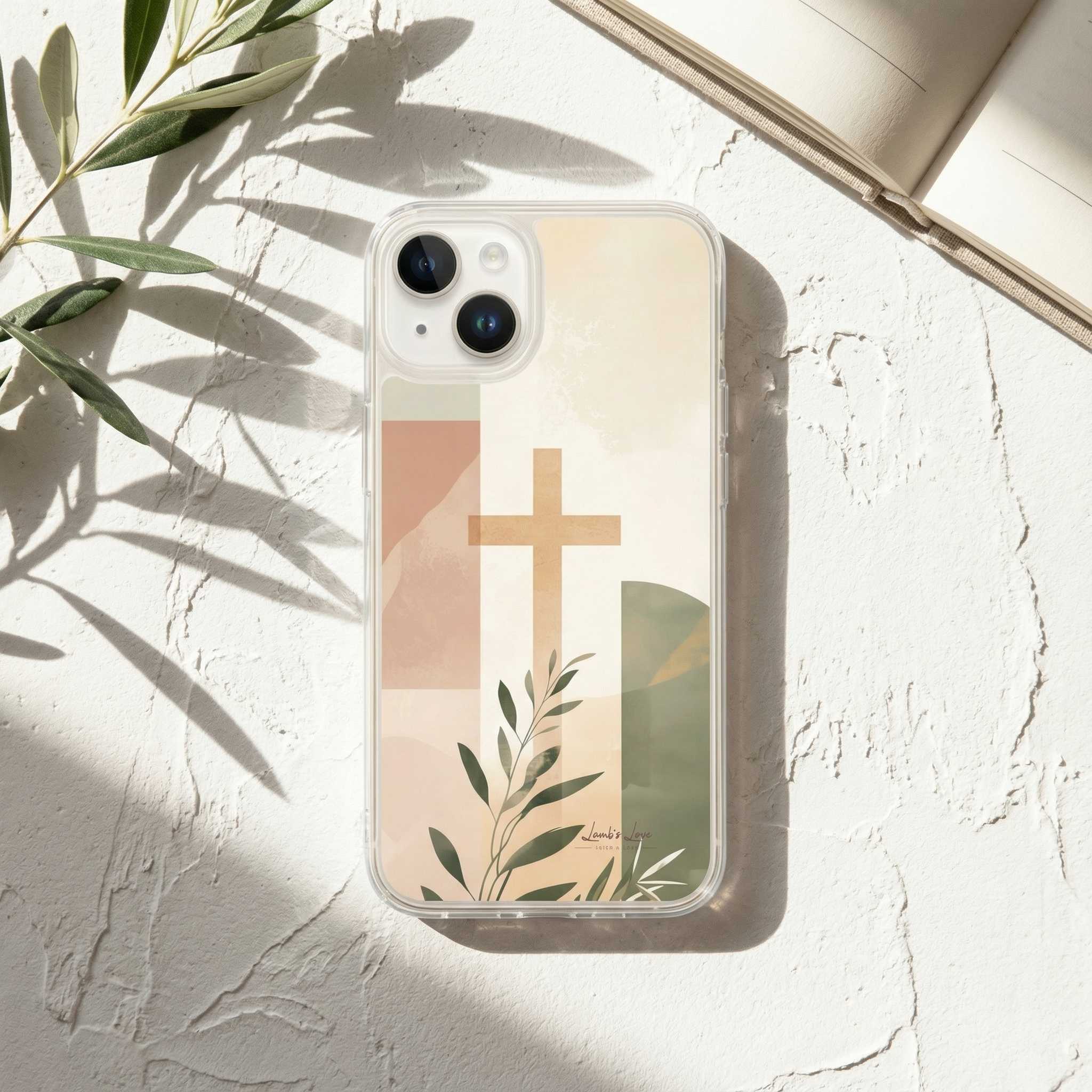 Phone case with cross and leaf design on a light surface