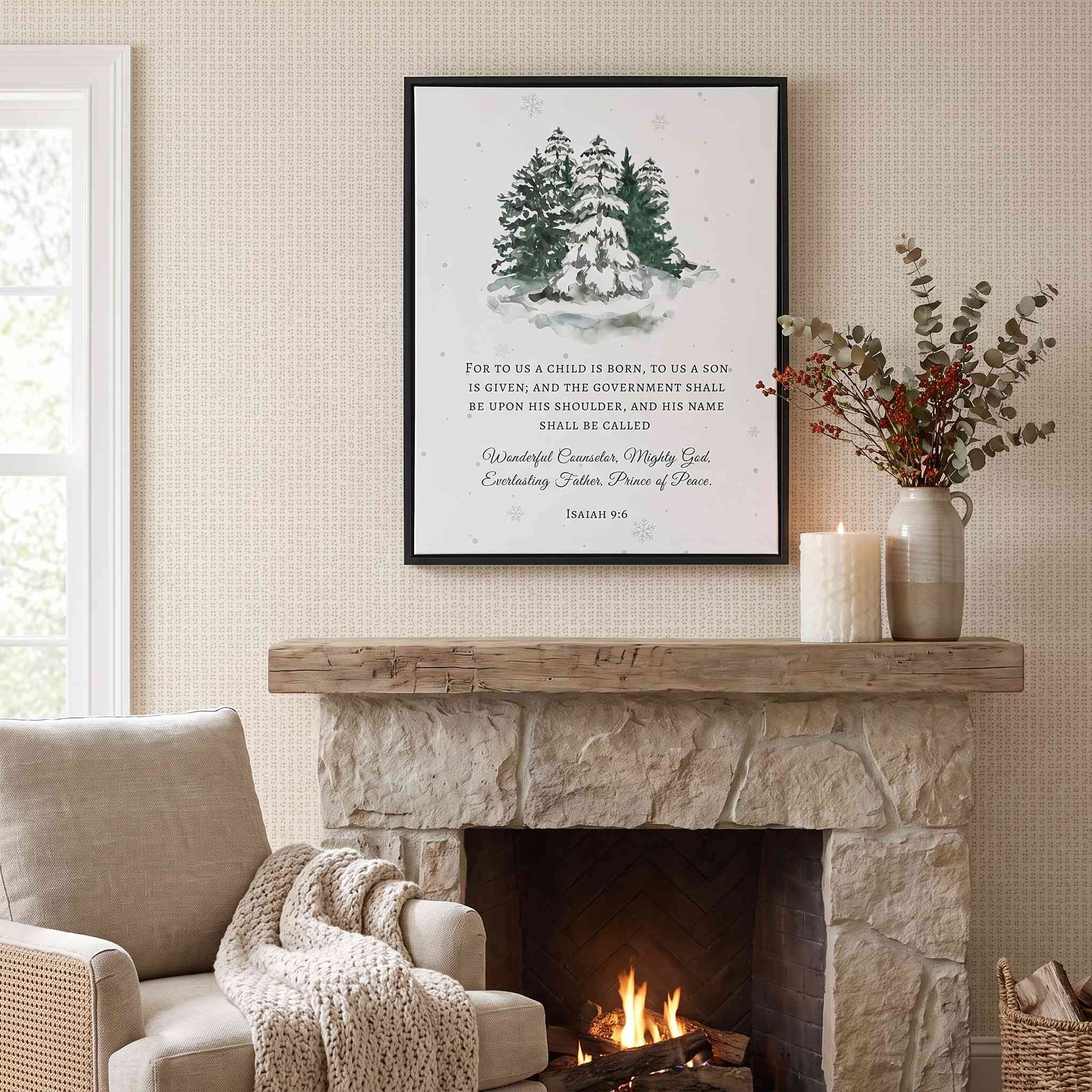 Our Savior Is Born Isaiah 9:6 framed canvas wall art with watercolor snowy pine trees displayed above a stone fireplace mantel with cozy Christmas living room decor.