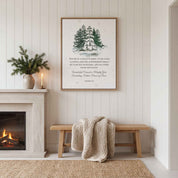 Our Savior Is Born Isaiah 9:6 framed canvas print with watercolor snowy pine trees displayed on a white paneled wall above a wooden bench next to a cozy fireplace.