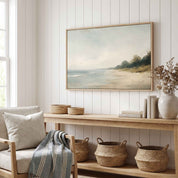 Framed vintage Mark 4:39 Christian landscape canvas wall art featuring a coastal beach scene hanging on a white shiplap wall above a light wooden console table with woven baskets and an armchair in a cozy living room.