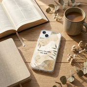 Aesthetic John 16:33 'Peace in the LORD' iPhone case with neutral botanical design, styled on a wooden table with a ceramic coffee mug, an open Bible, and dried eucalyptus branches