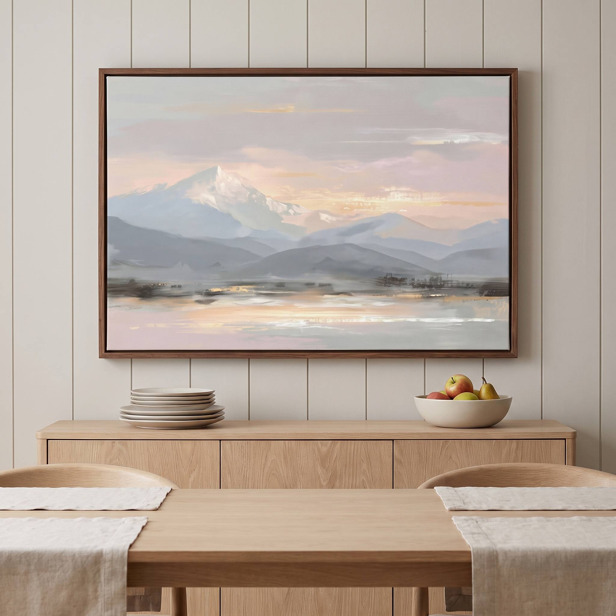 Framed Peace in the Mountains Christian landscape wall art with watercolor snow-capped mountains and a calm lake beneath a pastel sky, displayed above a dining table and sideboard.