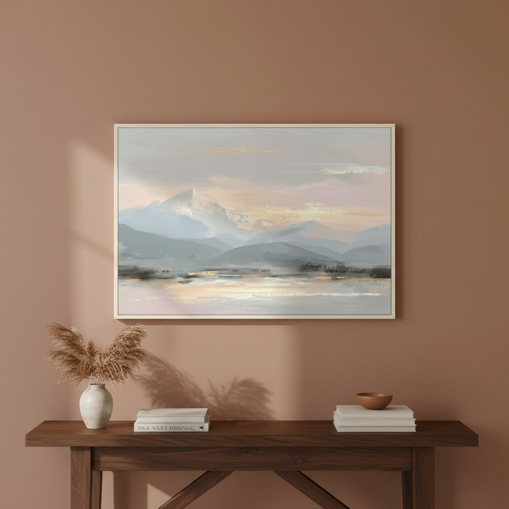 Soft tone mountain landscape art with gold and blush hues framed on a warm beige wall, evoking peace and balance.