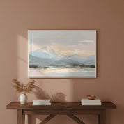 Soft tone mountain landscape art with gold and blush hues framed on a warm beige wall, evoking peace and balance.