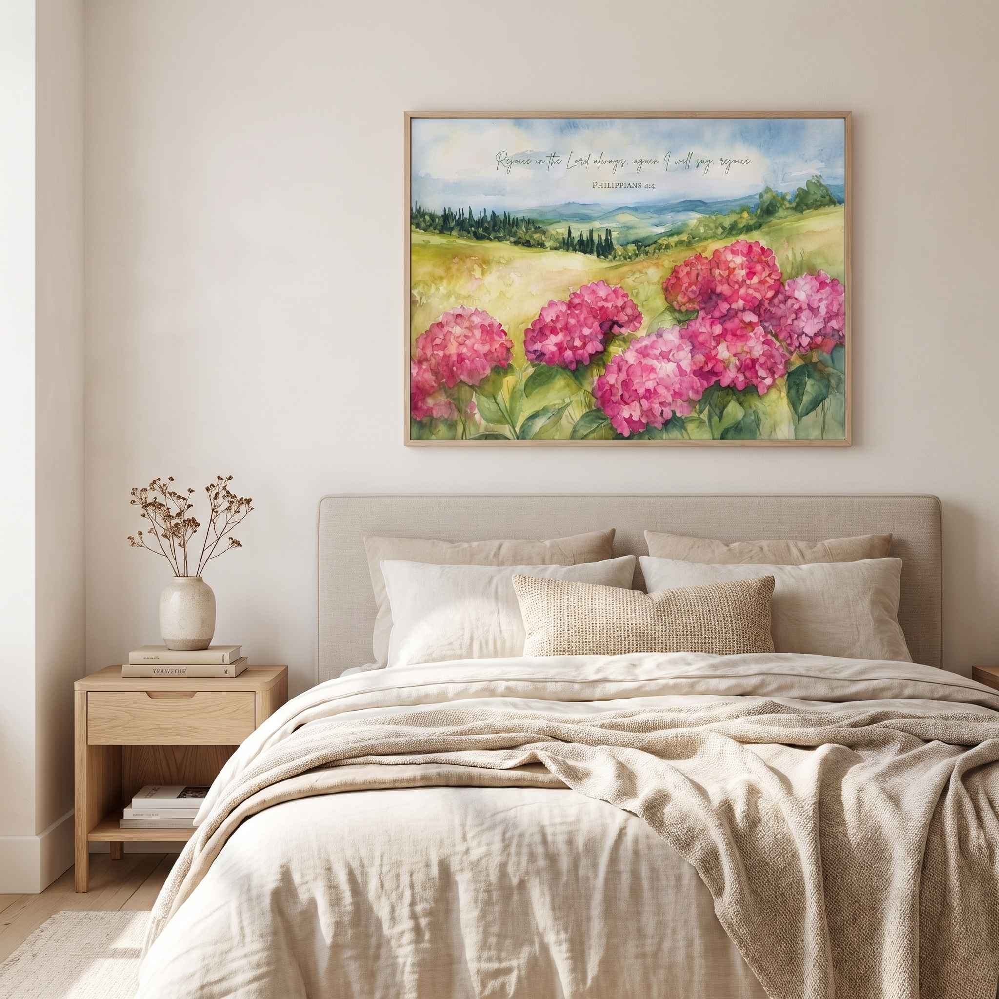 Framed watercolor hydrangea wall art with Philippians 4:4 scripture displayed above a bed in a neutral bedroom.