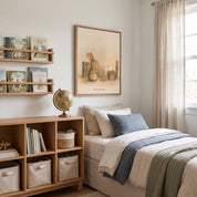 Framed Pray Always praying bunny Christian kids wall art above a bed with blue and cream bedding, beside wooden bookshelves and a globe.