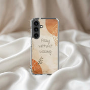 Christian Samsung phone case with 'Pray without ceasing' text on a beige background, placed on fabric.