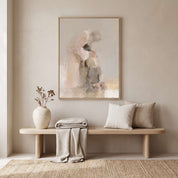 Watercolor Christian wall art of a father embracing his returning son, framed above an entryway bench with pillows and a vase in a neutral home interior.