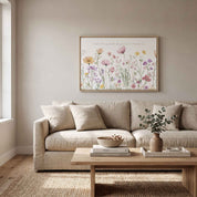 Framed Proverbs 3:5 watercolor wildflower wall art above a beige sofa in a calm neutral living room.