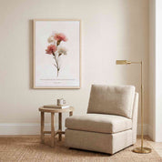 Framed vintage Christian floral wall art featuring Psalm 103:5 Scripture verse with watercolor wildflowers, displayed on a textured cream wall above a beige lounge chair and side table in a cozy reading nook.