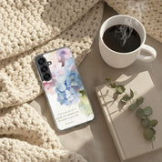 Fearfully and Wonderfully Made Christian Samsung Galaxy phone case with watercolor floral design on a cozy knit blanket with a cup of coffee and a "Morning Mercies" devotional book.