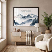 Framed Psalm 33:9 mountain Scripture wall art with misty blue gray peaks and cursive verse, styled above a light wood sideboard in a living room.