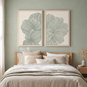 Two-piece framed canvas gallery wall set featuring Psalm 92:12–15 minimalist sage green botanical line art prints, displayed in light wood frames on a sage green wall above a bed with neutral beige linens in a soft organic modern bedroom.