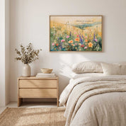 Psalm 96:12 wildflower Scripture wall art above a bed in a bright neutral bedroom, featuring a sunlit meadow of pink, yellow and purple flowers.