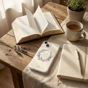 Phone case with floral design on a table with book, mug, and lavender