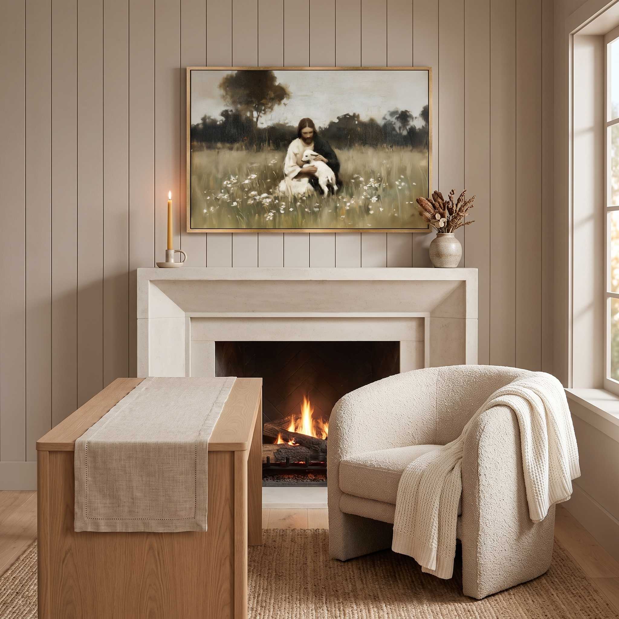 Framed vintage Christian wall art titled Rest in the Shepherd, depicting Jesus holding a lamb in a wildflower meadow, displayed above a fireplace mantel in a soft organic modern living room.