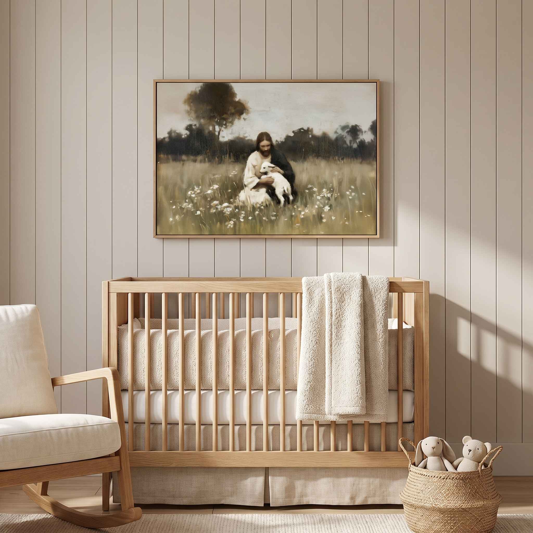 Framed vintage Christian wall art titled Rest in the Shepherd, depicting Jesus holding a lamb in a wildflower meadow, displayed above a light wood crib in a soft organic modern nursery.