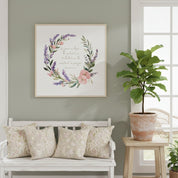 Watercolor wreath canvas wall art featuring Romans 12:12 scripture shown above sofa, adding a peaceful and faith-filled touch to home decor.