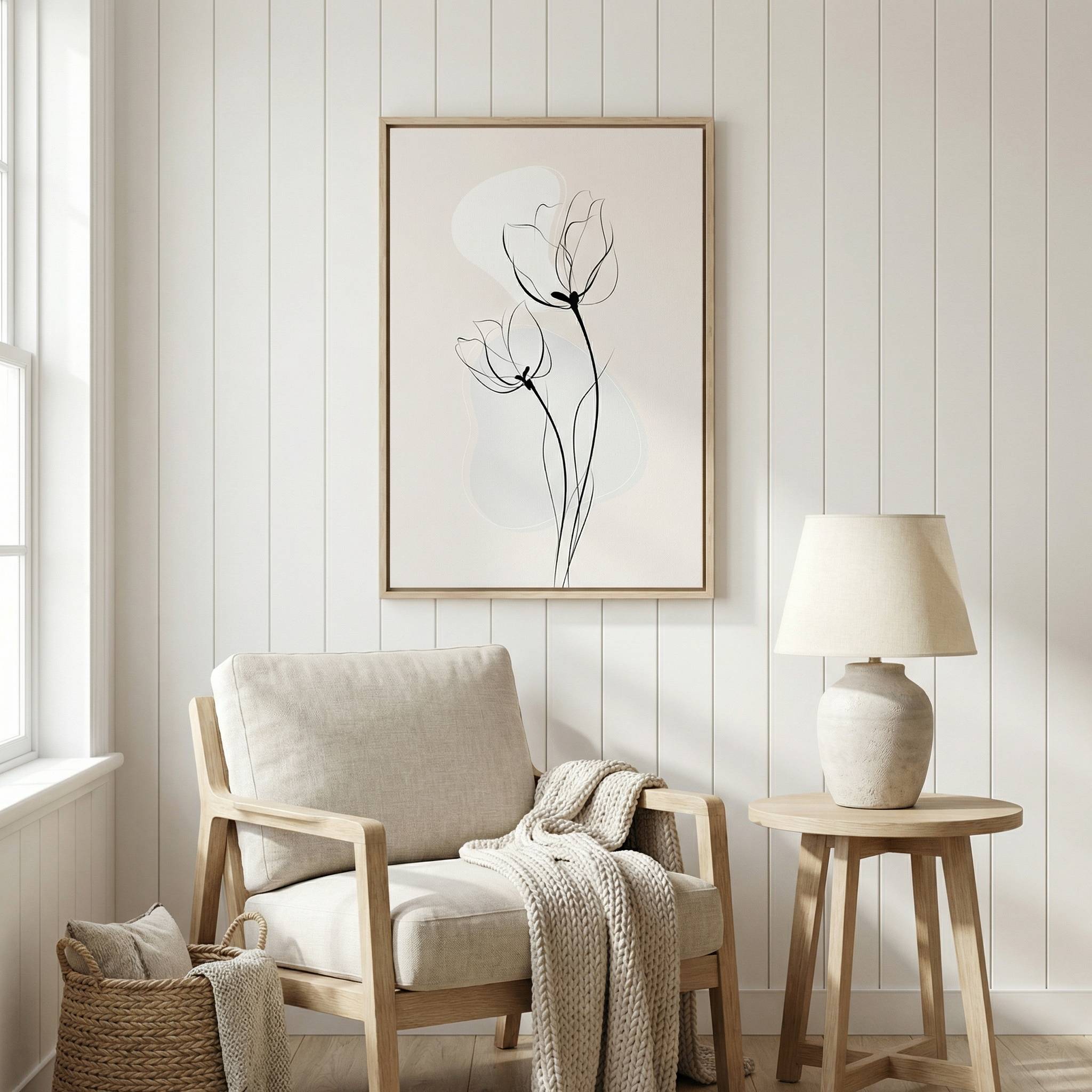Minimalist Floral Wall Art featuring tulip line drawing in a light wood frame, styled above a neutral armchair and wooden side table with a ceramic lamp.