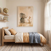 Framed Show Love elephant and bunny Christian kids wall art above a wooden bed with ochre bedding and a blue blanket in a bright child’s bedroom.