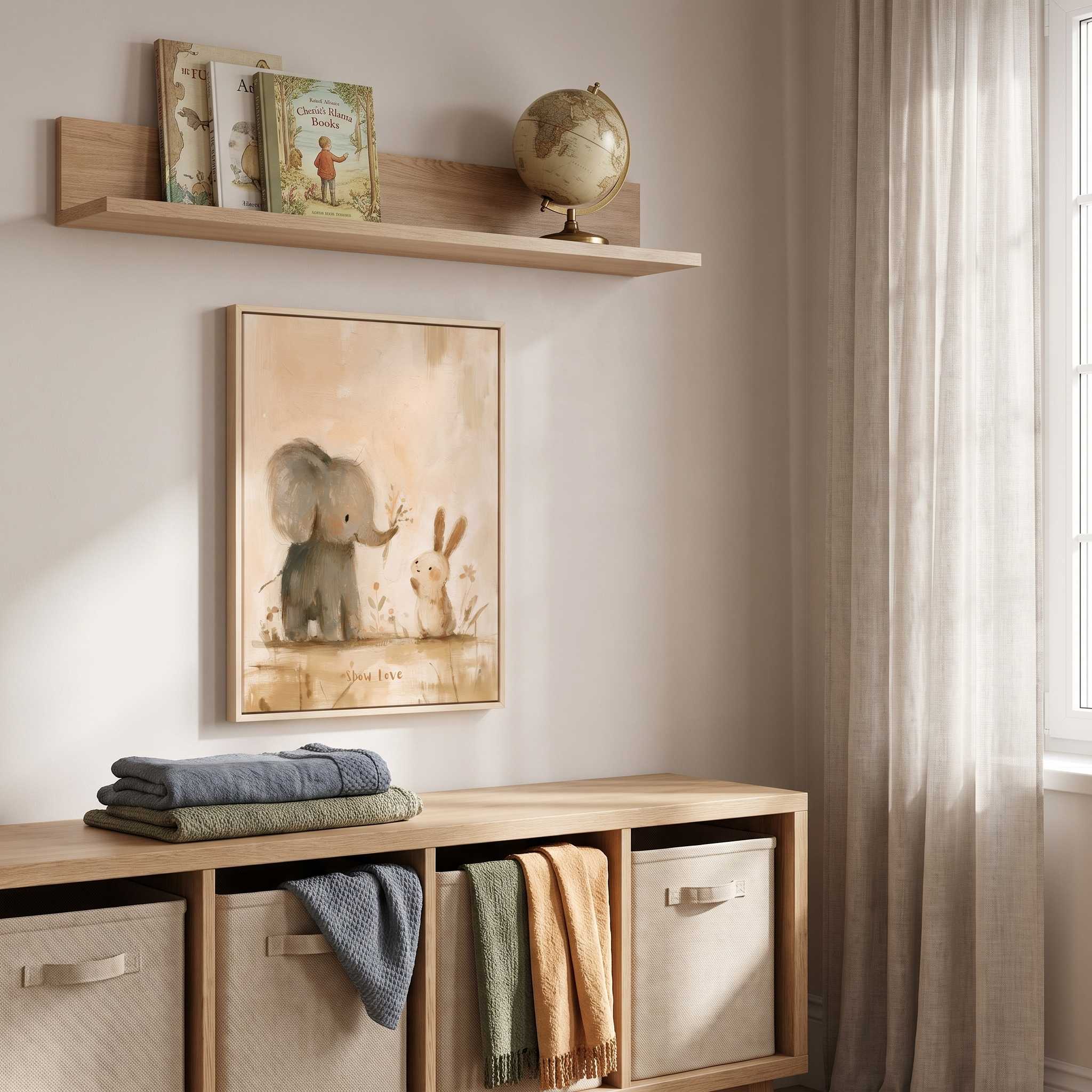Framed Show Love elephant and bunny Christian kids wall art above wooden storage cubbies, with books, a globe and folded blankets in a playroom.