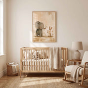 Show Love elephant and bunny Christian nursery wall art in a light wood frame above a wooden crib, beside a rocking chair in a neutral nursery.