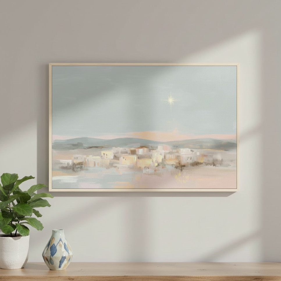 Watercolor wall art of Bethlehem under a shining star, inspired by Matthew 2:9, displayed on a white wall with a vase and plant.