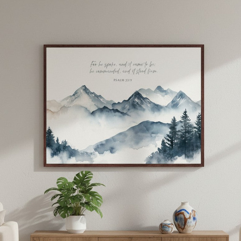 Framed watercolor mountain Scripture wall art of “Stood Firm by His Word” displayed above a sofa in a warm, elegant living room.