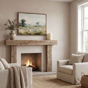 Framed vintage Psalm 34:8 wildflower landscape canvas wall art hanging above a rustic wood fireplace mantel with beige armchairs in a warm Christian living room.