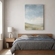 The Earth Is the Lord’s Christian landscape canvas showing hills and sheep beneath a blue sky above a wooden bed with gray bedding and a blue throw.