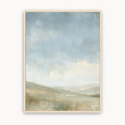 The Earth Is the Lord’s Christian landscape wall art with rolling green hills, grazing sheep and an expansive blue sky, in a light wood frame.
