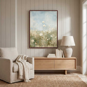 The Father Cares for You Christian floral wall art in a dark wood frame above a cabinet with books and a lamp beside a cream armchair in a paneled living room.