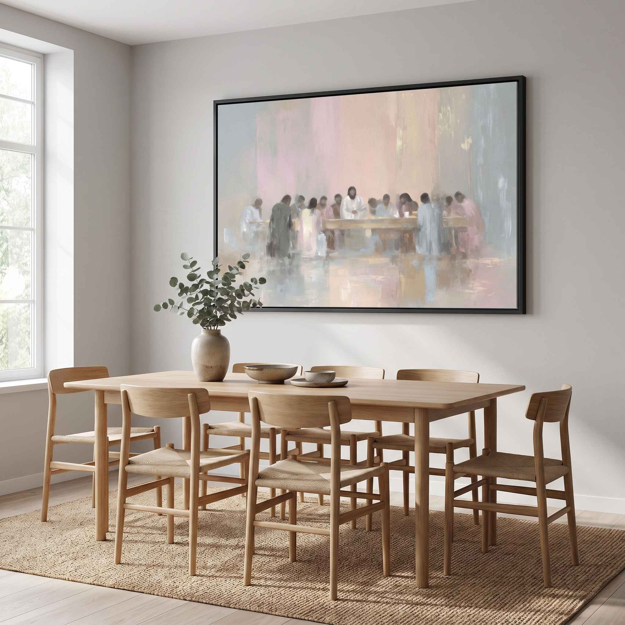 Large framed minimalist watercolor Last Supper Christian wall art in soft neutral tones hanging above a light wood table in a Scandinavian dining room.