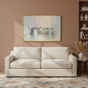 Framed watercolor Last Supper wall art portraying Jesus and disciples, hung above a beige sofa in a soft, inviting room.