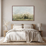 Framed vintage Psalm 103:8 wildflower landscape canvas wall art hanging above a light wood bed in a soft organic modern bedroom.