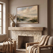 Framed vintage Psalm 27:1 Christian landscape canvas wall art featuring coastal dunes hanging above a rustic stone fireplace mantel with woven armchair seating in a cozy living room.