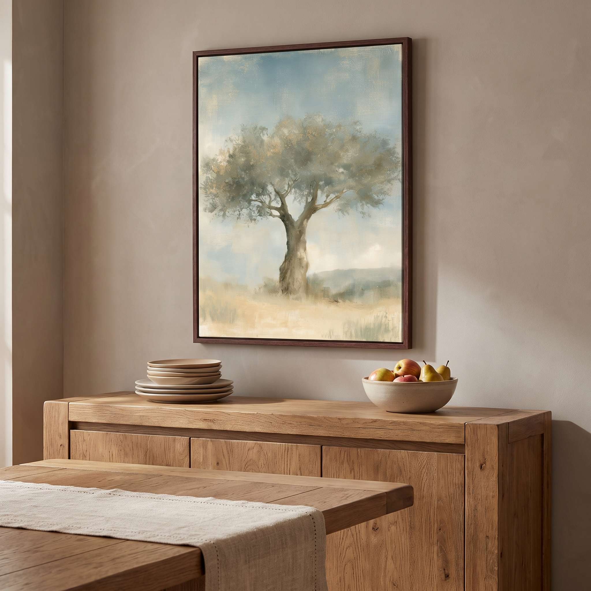 Trust in His Steadfast Love olive tree Christian wall art in a dark wood frame above a rustic dining room sideboard with stacked plates and a fruit bowl.