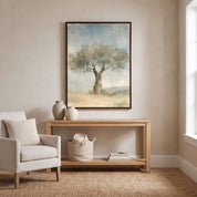 Framed Trust in His Steadfast Love olive tree Christian wall art above a light wood console with pottery and a woven basket beside a cream armchair.