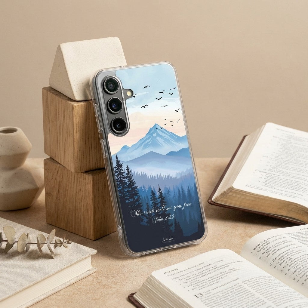 Samsung Christian phone case with mountain and forest design on a table with books and decor