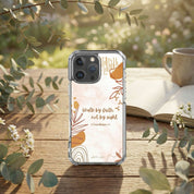 Phone case with motivational quote on a wooden surface with nature elements