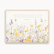 Framed artwork with yellow and purple floral design and scripture on a white background